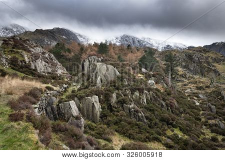 Stunning Dramatic Landscape Images Of Ogwen Valley In Snowdonia During Winter With Snowcapped Glyers
