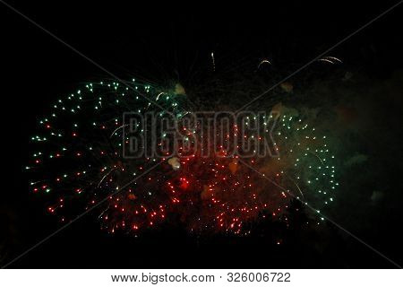 The Celebration Mutlicolored Firework Flashing In The Black Night Sky Background