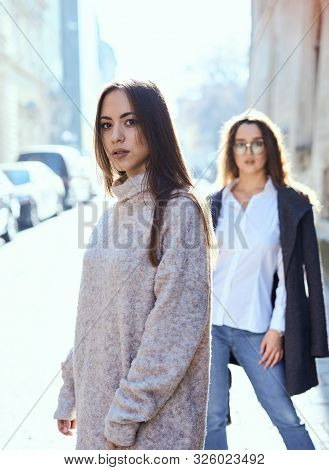 Unhappy Lgbt Lesbian Couple In The Street Of The City. Dissapointed Beautiful Brunette Woman In Quar
