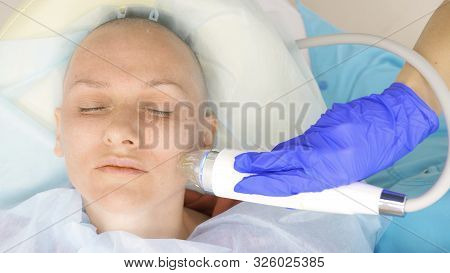 Close-up. Microneedle Rf Lifting Procedure. Hardware Cosmetology. Beautician Conducts A Facial Rejuv
