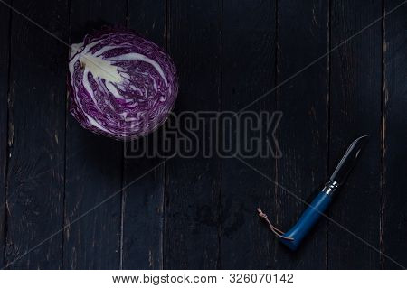 Sliced Cabbage With A Knife. Purple Cabbage And A Blue Knife.