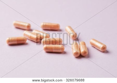Goji Berry (wolfberry) Capsules. Immune System Support. Dietary Supplement On Pink Paper Background.