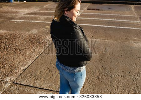 Happy Young Curvy Woman Looking Up Outdoors In Fall. Girl Enjoying Warm Sunny Weather. She Wearing I