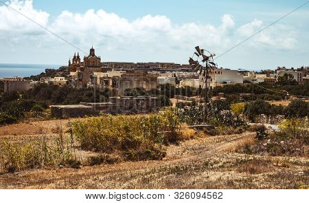 Hill With Terraced Fields For Agriculture And Old Buildings In Ghajnsielem, Gozo Island, Malta