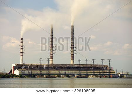 Thermal Power Station Tall Pipes With Thick Smoke Reflected In Lke Water Surface. Pollution Of Envir