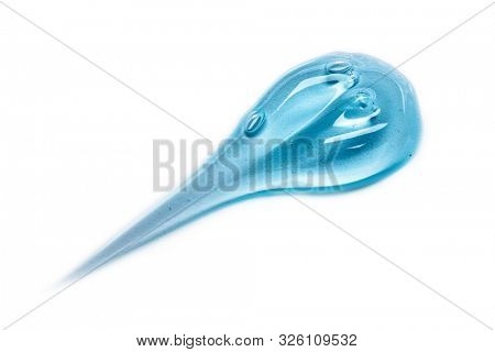 Squeezed cosmetic clear cream gel texture Iisolated on white background. Close up photo of transparent drop of skin care product. High Quality transparent gel with bubbles closeup on white background