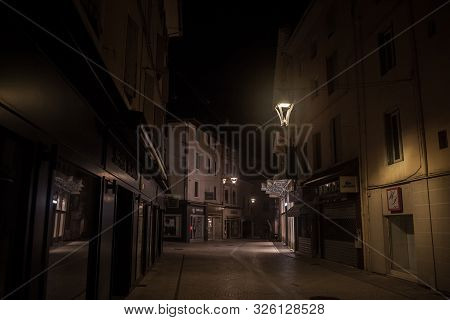 Bourgoin-jallieu, France - July 15, 2019: Rue De La Liberte, A Dark & Empty Pedestrian Street With T