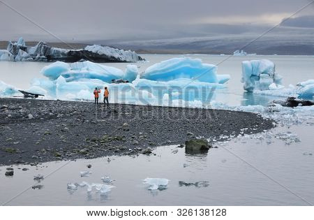 Tourists on the shoe of Jokullsarlon Laguna, Iceland, Europe