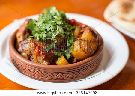 Roasted Meat With Potatoes, Ojaxuri, Hot In Georgian On A Wooden Table. Georgian Cuisine
