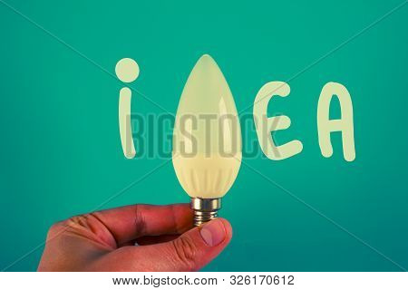 Idea Concept. Blue Background. Lamp Bulb. Copy Space