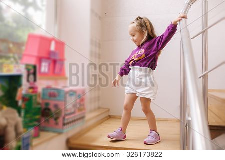 Happy Little Girl Walkning In Toy Store. Cute Girl Choose Toy. Adorable Female In Kids Mall