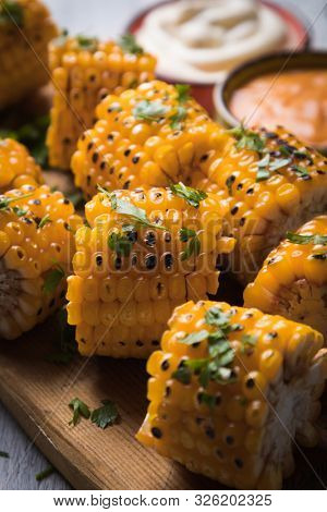 Sweet corn slices grilled and spiced as healthy party food alternative