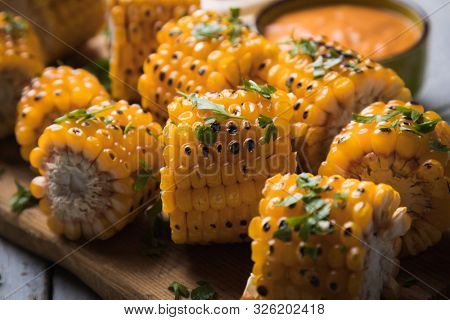 Sweet corn slices grilled and spiced as healthy party food alternative