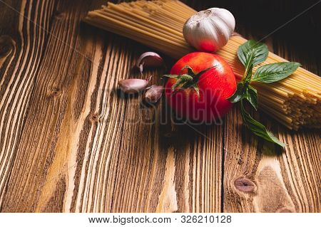 Tasty Appetizing Italian Spaghetti Pasta Ingredients For Kitchen Cuisine With Tomato, Garlic And Bas