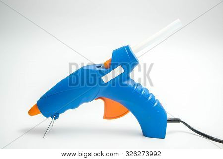 Hot Glue Gun Blue And Orange Close Up And Isolated On White Hand