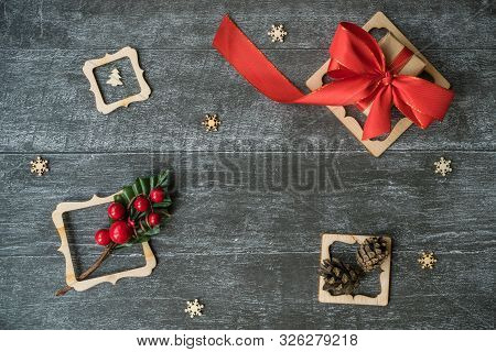 Christmas Background With Decorative Composition Of Wooden Frame, Pine Cone And Snowflakes On Wooden