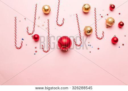 Creative New Year Or Christmas Banner With Striped Sweets, Gold And Red Balls, Gliter Star Decor On 