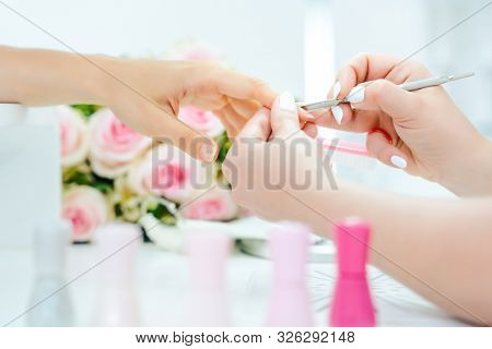 Woman having a manicure in beauty parlor