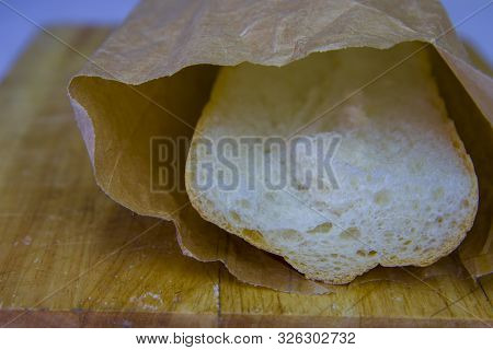 Fresh Baguette In A Paper Bag Closeup Copy Space.