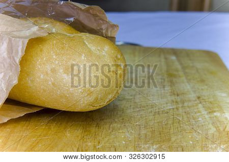 Fresh Baguette In A Paper Bag Closeup Copy Space.
