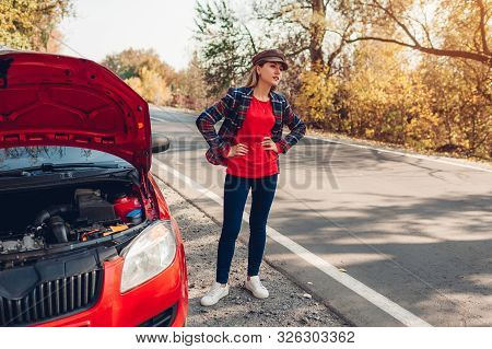 Broken Car. Sad Woman Standing On Road By Her Auto With Hood Open Stopping Autos And Waiting For Hel
