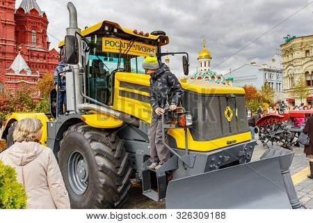 Moscow, Russia - October 05, 2019: Young Man On The Board Of Russian Contemporary Wheeled Tractor Ki