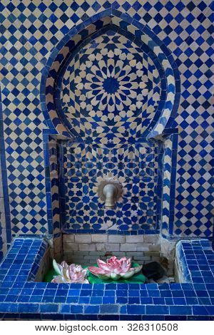 Beautiful water fountain decorated with moroccan tiles in Asilah, Morocco