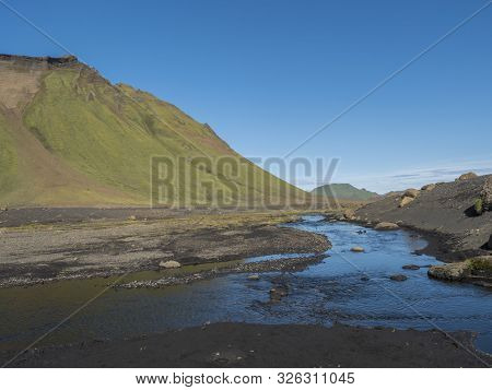 Blue River Stream And Green Hattafell Mountain In Volcanic Landscape Behind Emstrur Camping Site In 