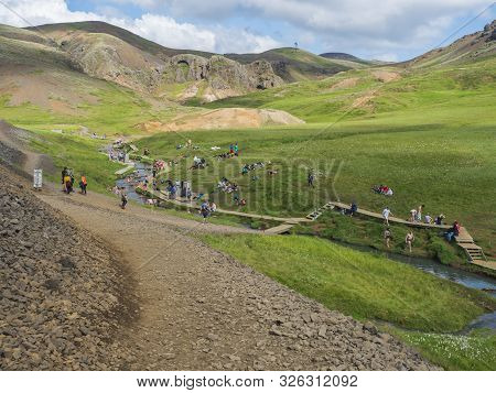 Iceland, Hveragerdi, August 5, 2019: Crowded Natural Geothermal Bath In A Hot River Stream In Reykja