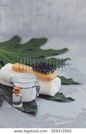 Body Hair Spa Treatment Bamboo Brushes With Bathtowel On Green Tropical Leaf, Concrete Background