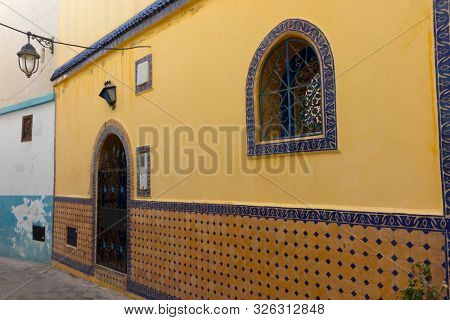 Facade of a traditional house decorated with tiles in the medina of Assilah, Morocco