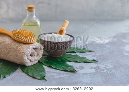 Body Hair Spa Treatment Bamboo Brush With Bathtowel And Oil On Green Tropical Leaf, Concrete Backgro