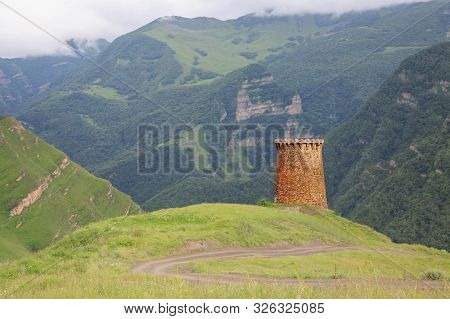 Ancient Stone Watchtower In The Caucasus Mountains.