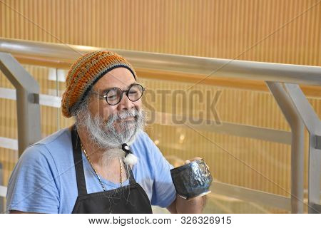 Bangkok, Thailand 08.23.2019: A Very Kind Thai Artist Is Resting And Drinking During The Making Of A