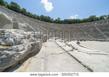 Epidaurus Greece - July 19 2019; Ancient Epidaurus Theatre Stone Seating Rows With Modern Numbers Ad