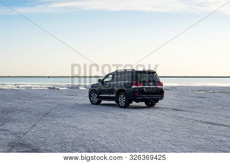 Toyota Land Cruiser Suv Stands On The Shore Of The Salt Lake Burlinskoye. Village Bursol. Slavgorod 