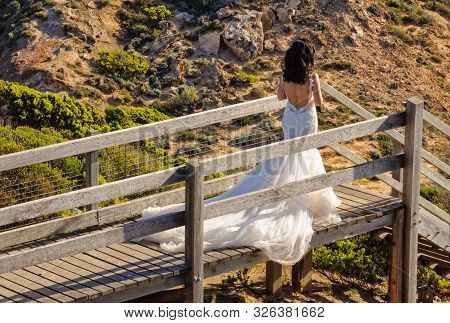A Bride In Her Beautiful Wedding Dress On The Boardwalk At Cape Schenk On The Mornington Peninsula -