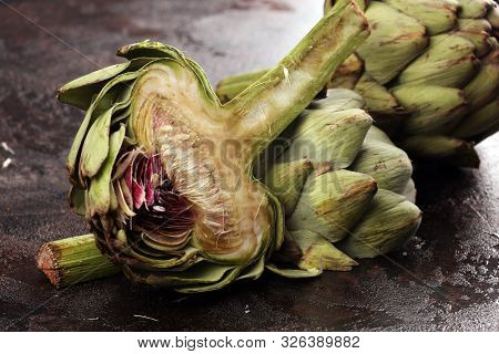 Artichokes On Rustic Dark Background. Fresh Organic Artichoke Flower.