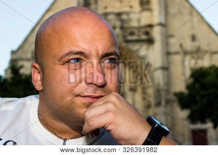 Portrait Of A Young Tourist In Front Of The Catholic Cathedral In Honfleur, France, 2019