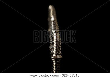 Lot Of Whole Glossy Metallic Glossy Bolt In Row Isolated On Black Glass