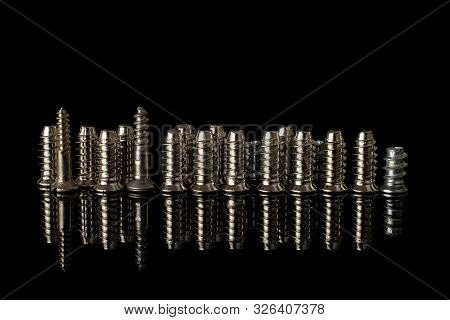 Lot Of Whole Metallic Glossy Bolt In Row Isolated On Black Glass