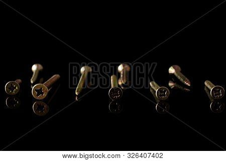Group Of Nine Whole Metallic Glossy Bolt Isolated On Black Glass