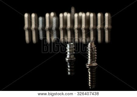 Lot Of Whole Metallic Glossy Bolt Isolated On Black Glass