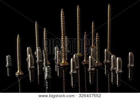 Lot Of Whole Metallic Glossy Bolt Isolated On Black Glass