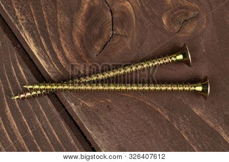 Group Of Two Whole Long Metallic Glossy Bolt Flatlay On Brown Wood