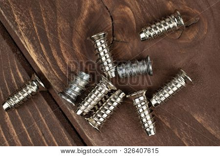 Group Of Nine Whole Metallic Glossy Bolt Flatlay On Brown Wood