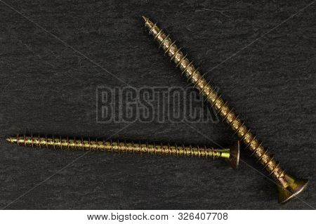 Group Of Two Whole Metallic Glossy Bolt Flatlay On Grey Stone