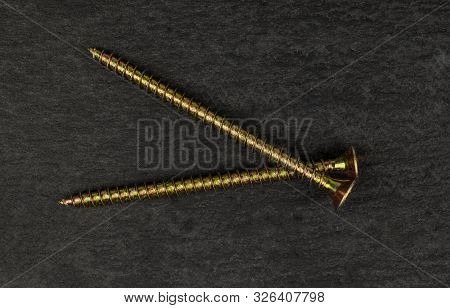 Group Of Two Whole Metallic Glossy Bolt Flatlay On Grey Stone