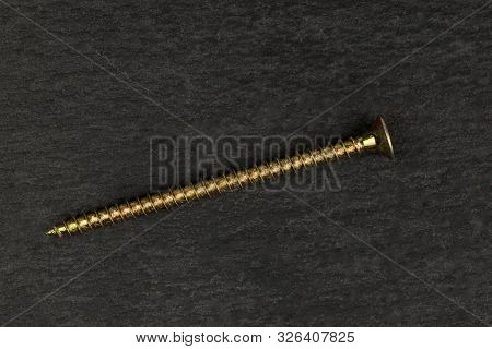 One Whole Long Metallic Glossy Bolt Flatlay On Grey Stone