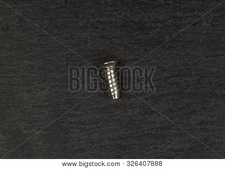 One Whole Metallic Glossy Bolt Flatlay On Grey Stone